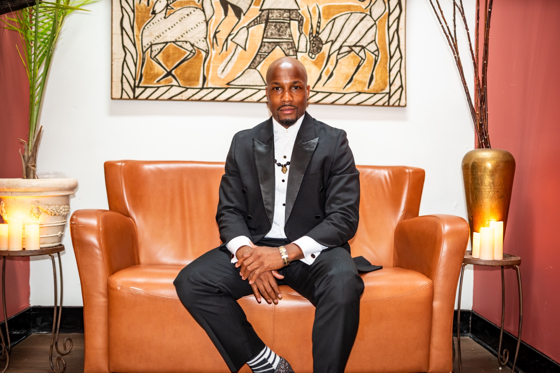 Elias Hendricks seated for a portrait before the candlelit concert